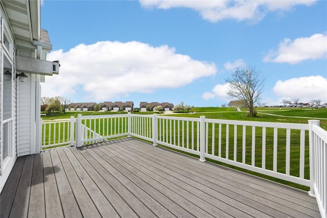wooden terrace featuring a lawn and a residential view