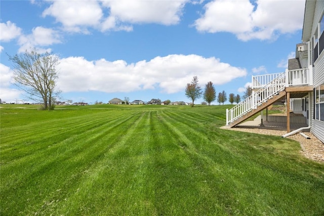 view of yard with stairway and a deck