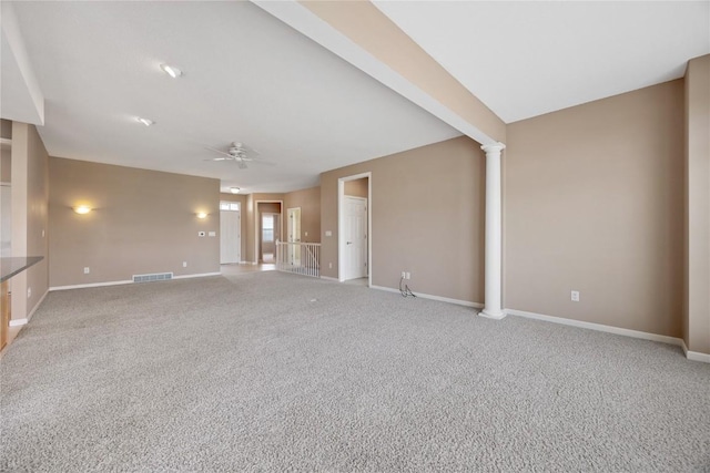 unfurnished living room featuring visible vents, baseboards, ceiling fan, ornate columns, and light colored carpet