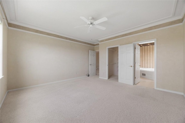 unfurnished bedroom with crown molding, baseboards, and carpet flooring