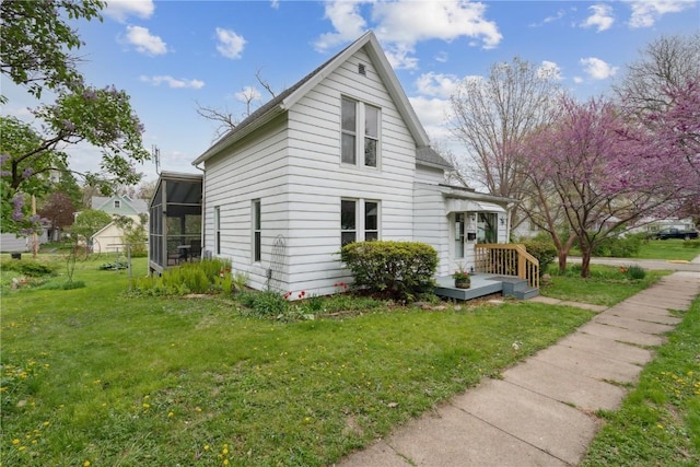 view of property exterior featuring a lawn and a sunroom