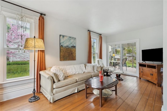 living room featuring hardwood / wood-style flooring and a notable chandelier