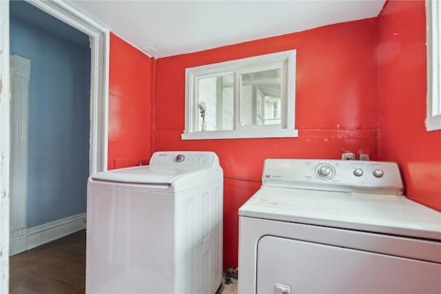 clothes washing area featuring independent washer and dryer, laundry area, and wood finished floors
