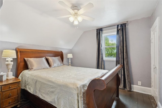 bedroom featuring baseboards, dark wood finished floors, ceiling fan, and vaulted ceiling