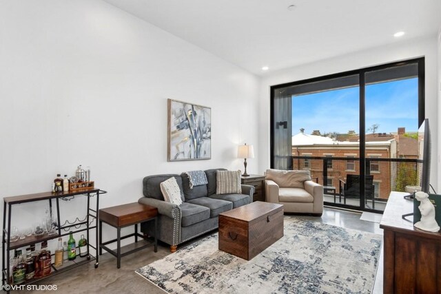 living area featuring finished concrete flooring and recessed lighting