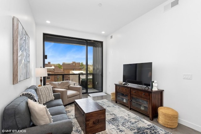 living room featuring recessed lighting, baseboards, and visible vents