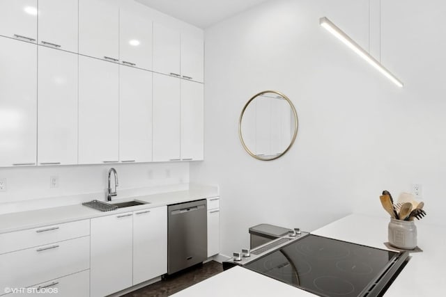 kitchen featuring a sink, light countertops, white cabinetry, stainless steel dishwasher, and black range with electric stovetop