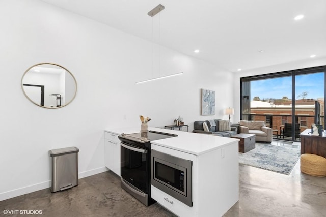 kitchen with appliances with stainless steel finishes, a peninsula, baseboards, recessed lighting, and finished concrete floors