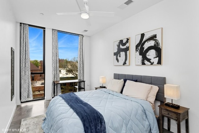 bedroom featuring baseboards, a wall of windows, ceiling fan, and visible vents