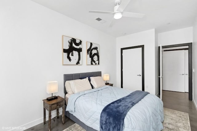 bedroom with visible vents, baseboards, and finished concrete flooring