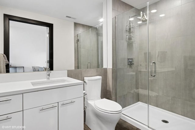 full bath featuring toilet, visible vents, a shower stall, and vanity