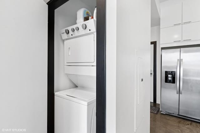 laundry room featuring stacked washer and dryer and laundry area