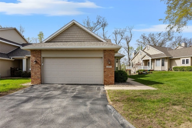 view of front of home featuring brick siding, a garage, a front lawn, and driveway