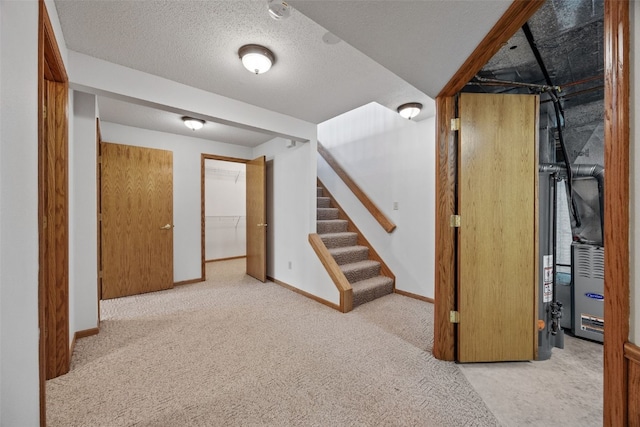 finished below grade area featuring baseboards, carpet flooring, and stairs