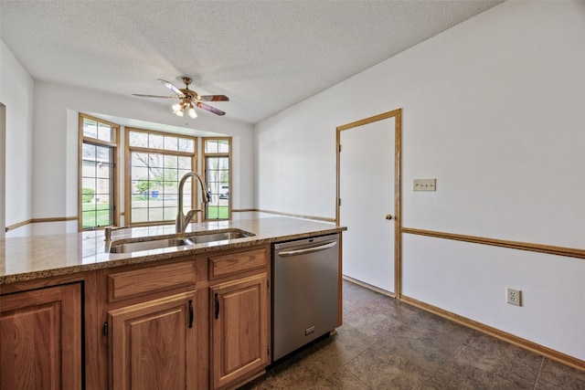 kitchen with a ceiling fan, brown cabinets, dishwasher, a sink, and light stone counters