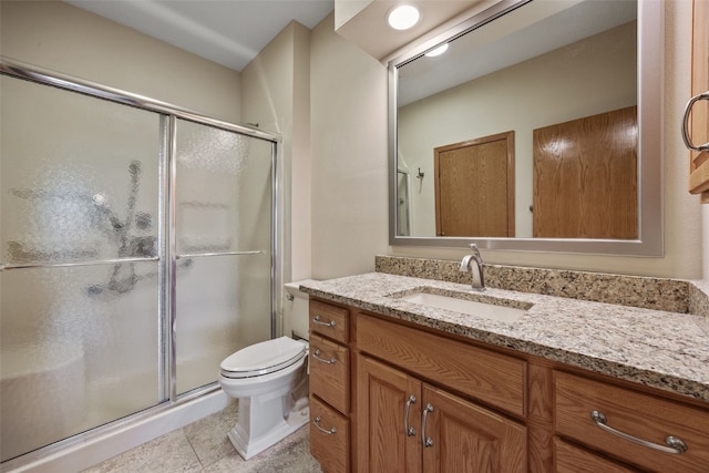 full bathroom featuring vanity, tile patterned floors, a shower stall, and toilet