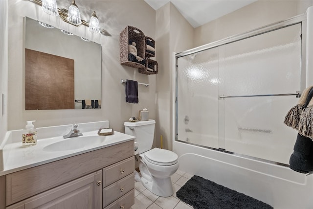 full bathroom featuring vanity, tile patterned flooring, combined bath / shower with glass door, and toilet