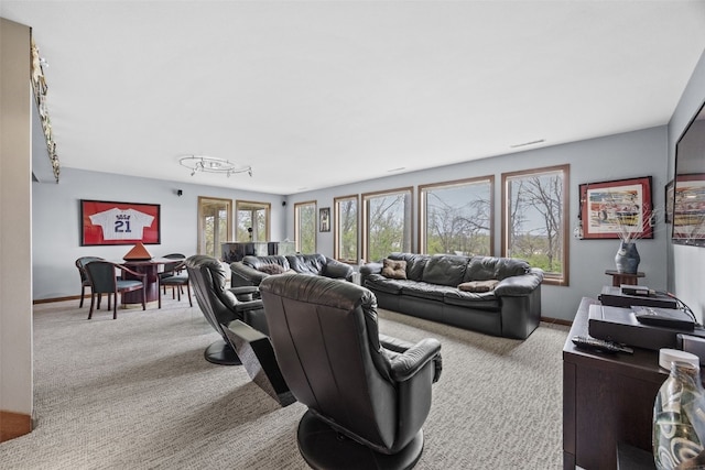 living area featuring baseboards and carpet