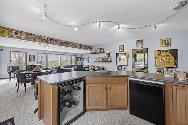 kitchen featuring light colored carpet, dark countertops, track lighting, open floor plan, and wine cooler