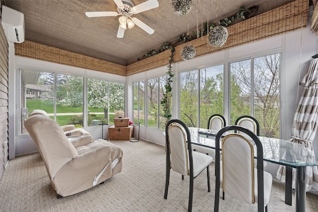 sunroom / solarium with french doors, outdoor dining space, ceiling fan, and a wall unit AC