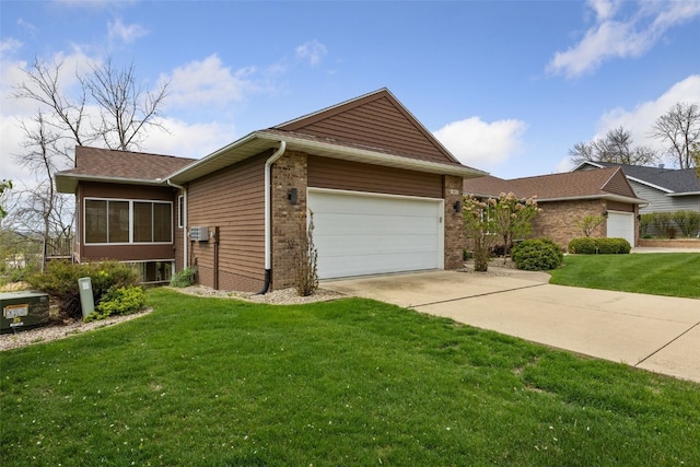 view of side of property with brick siding, a garage, a yard, and concrete driveway