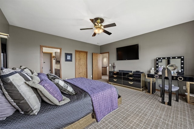 carpeted bedroom featuring ceiling fan and ensuite bathroom
