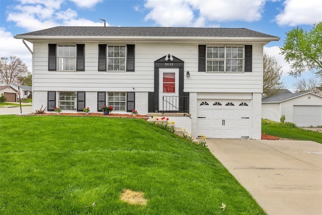 bi-level home featuring concrete driveway, brick siding, an attached garage, and a front lawn