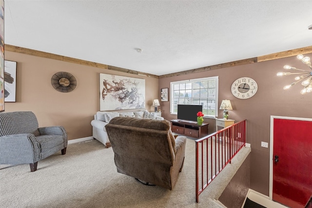 carpeted living room featuring baseboards and an inviting chandelier