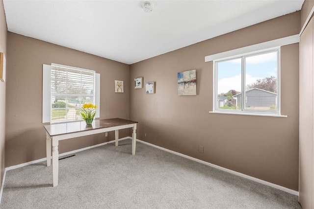 home office featuring carpet flooring, baseboards, and plenty of natural light