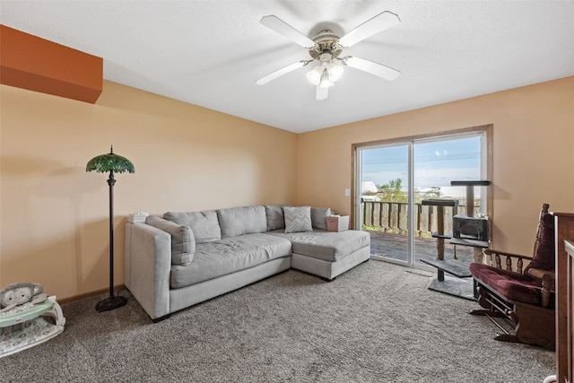 living area with carpet floors, a ceiling fan, and baseboards