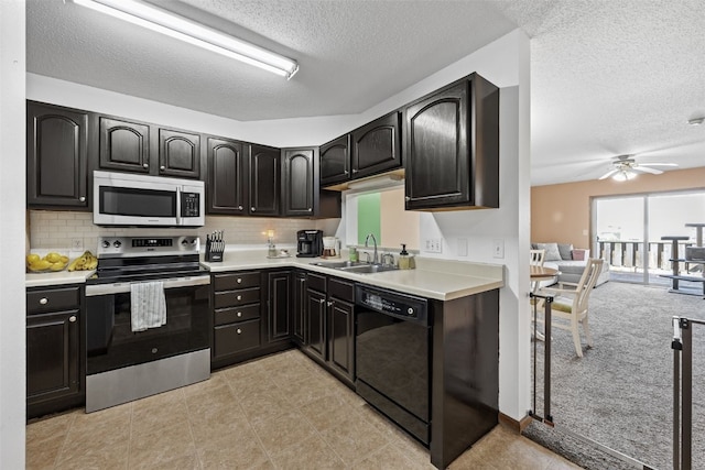 kitchen with ceiling fan, a textured ceiling, tasteful backsplash, a sink, and stainless steel appliances