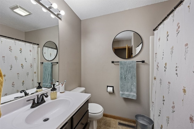 bathroom featuring visible vents, tile patterned flooring, baseboards, vanity, and toilet