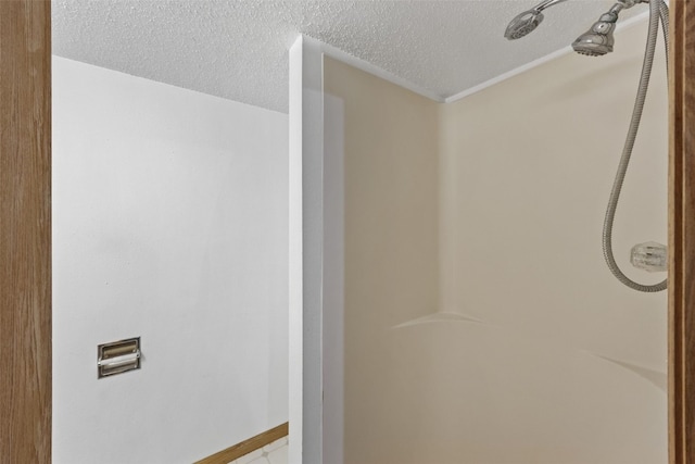 full bath featuring a textured ceiling and a shower