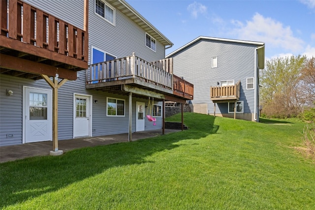 back of property featuring a yard and a deck