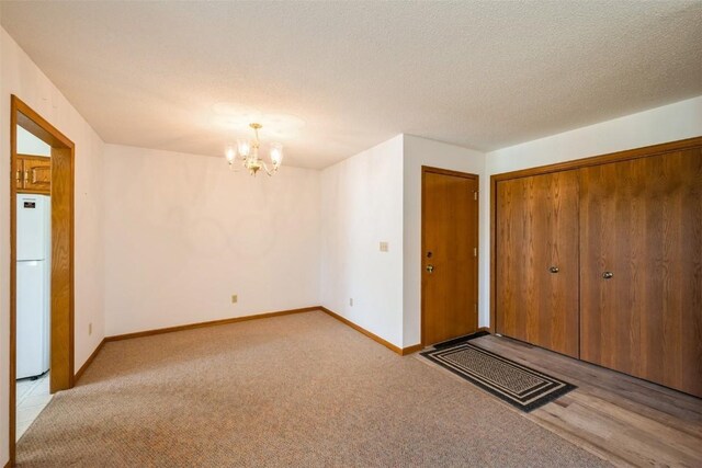 interior space featuring baseboards, carpet, and a notable chandelier