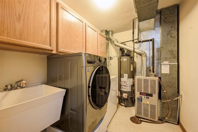 laundry room featuring cabinet space, a sink, gas water heater, washer / dryer, and heating unit