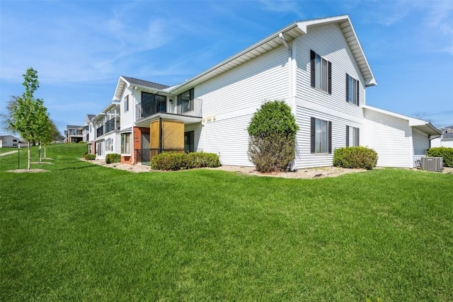 view of home's exterior with a lawn and cooling unit