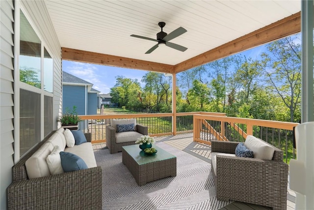 wooden terrace featuring ceiling fan and an outdoor living space