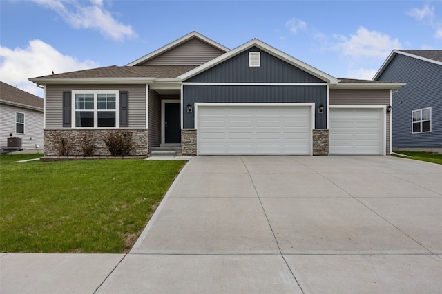 1330 Chipman Ln, North Liberty, IA 52317 - craftsman house with driveway, a front yard, central air condition unit, an attached garage, and stone siding