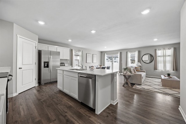 1330 Chipman Ln, North Liberty, IA 52317 - kitchen with a sink, light countertops, white cabinets, open floor plan, and stainless steel appliances