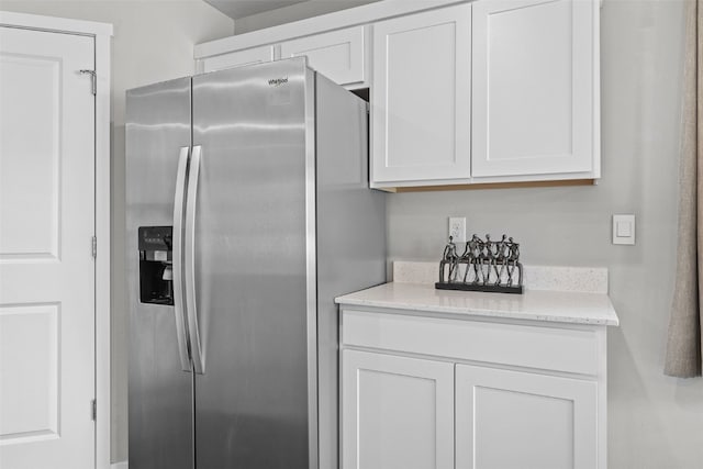 1330 Chipman Ln, North Liberty, IA 52317 - kitchen with white cabinets, stainless steel refrigerator with ice dispenser, and light stone countertops