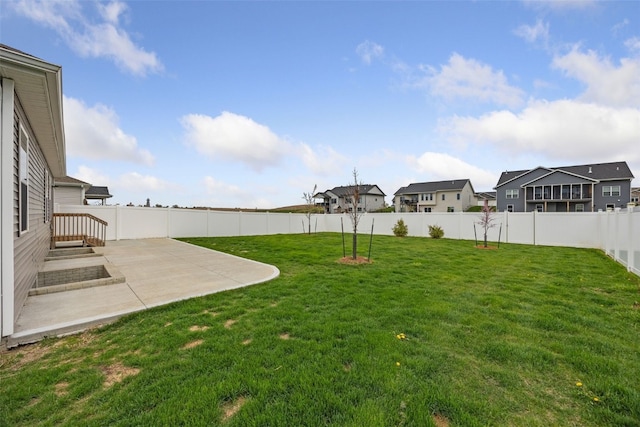 view of yard with a patio, a residential view, and a fenced backyard