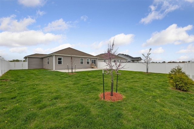 view of yard with a fenced backyard and a patio