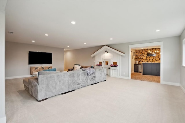 living room with baseboards, recessed lighting, and light colored carpet