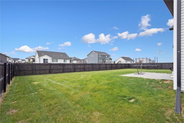 view of yard with a residential view, a fenced backyard, and a patio area