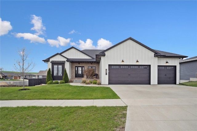 modern farmhouse featuring a garage, a front lawn, french doors, board and batten siding, and driveway