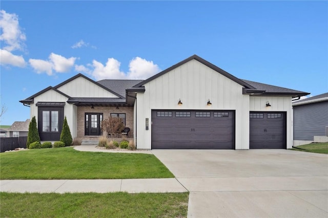 modern farmhouse style home with a garage, a front lawn, french doors, board and batten siding, and concrete driveway