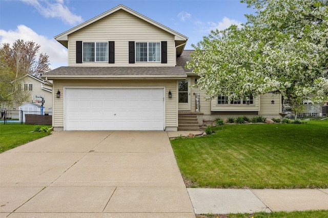 tri-level home with fence, a shingled roof, a front lawn, a garage, and concrete driveway