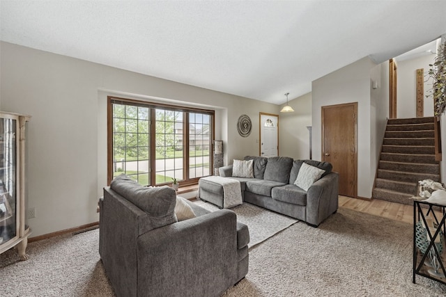living room featuring stairs, light colored carpet, and vaulted ceiling