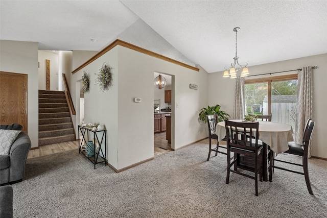 dining area with light colored carpet, vaulted ceiling, stairway, baseboards, and a notable chandelier